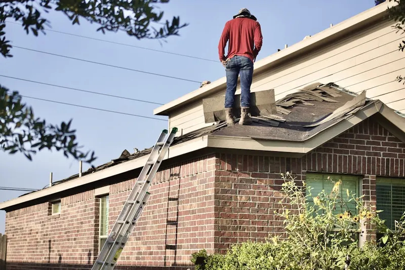 Professional roofer working on a residential roof in Grace Villa